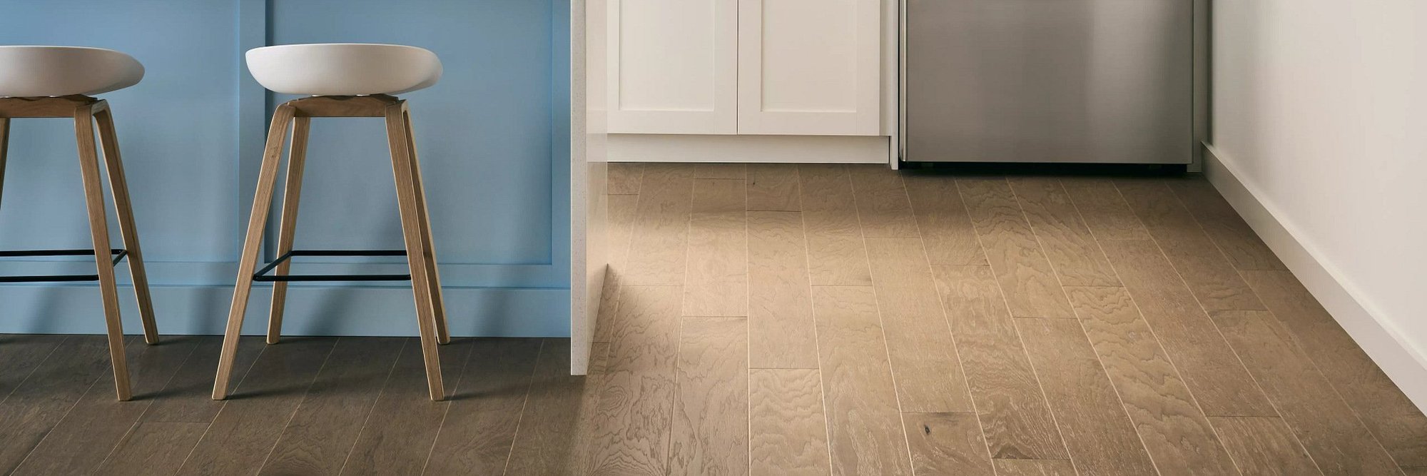 Kitchenette Area With Vinyl Plank Flooring And Stools