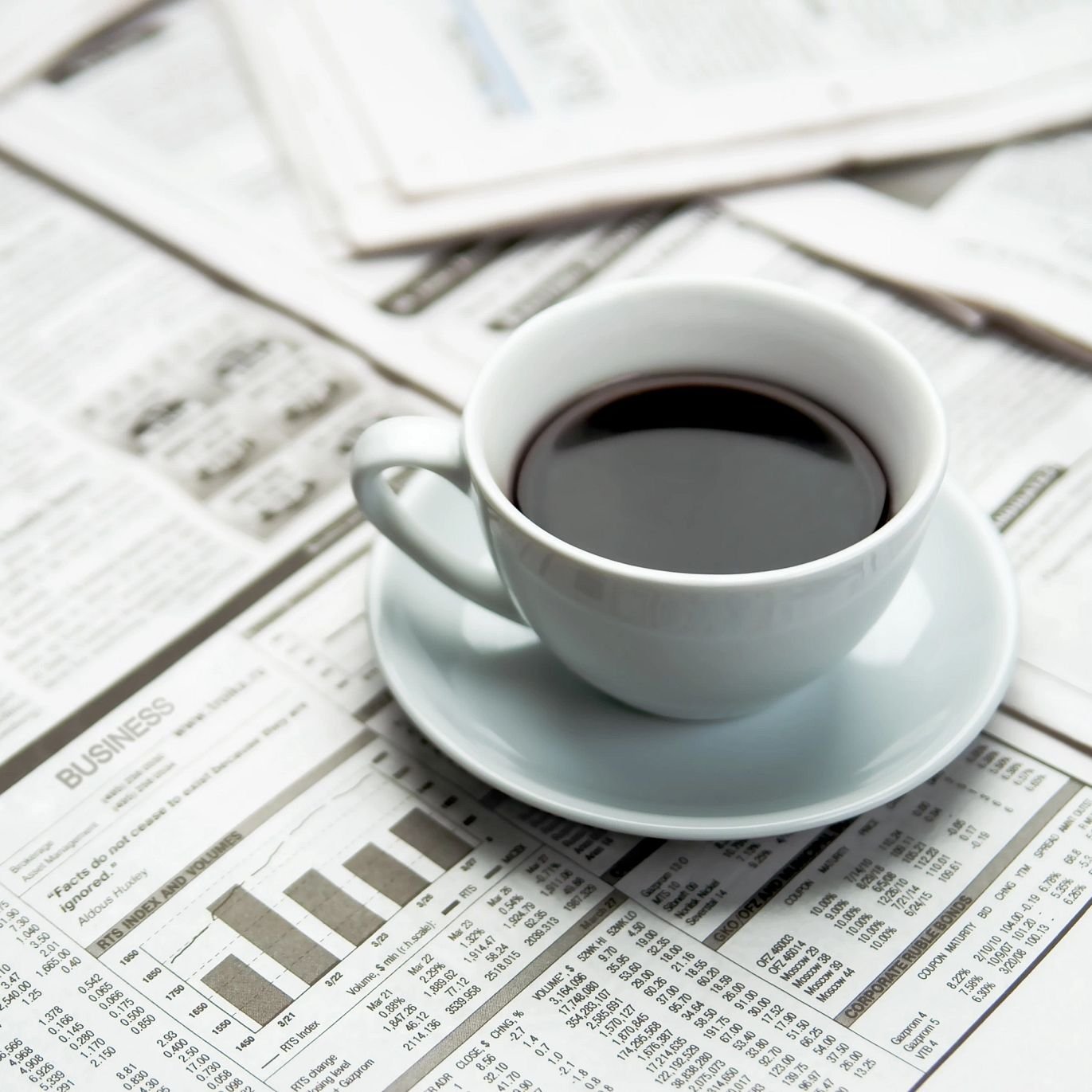 Cup Of Coffee On A Pile Of Assorted Paper Documents